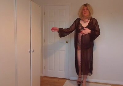 blonde stripping out of a negligee and lace gown