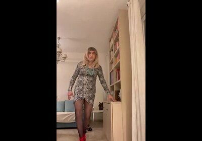 Beautiful blonde Spanish trans girl poses in high red heels and lingerie with a sexy dress